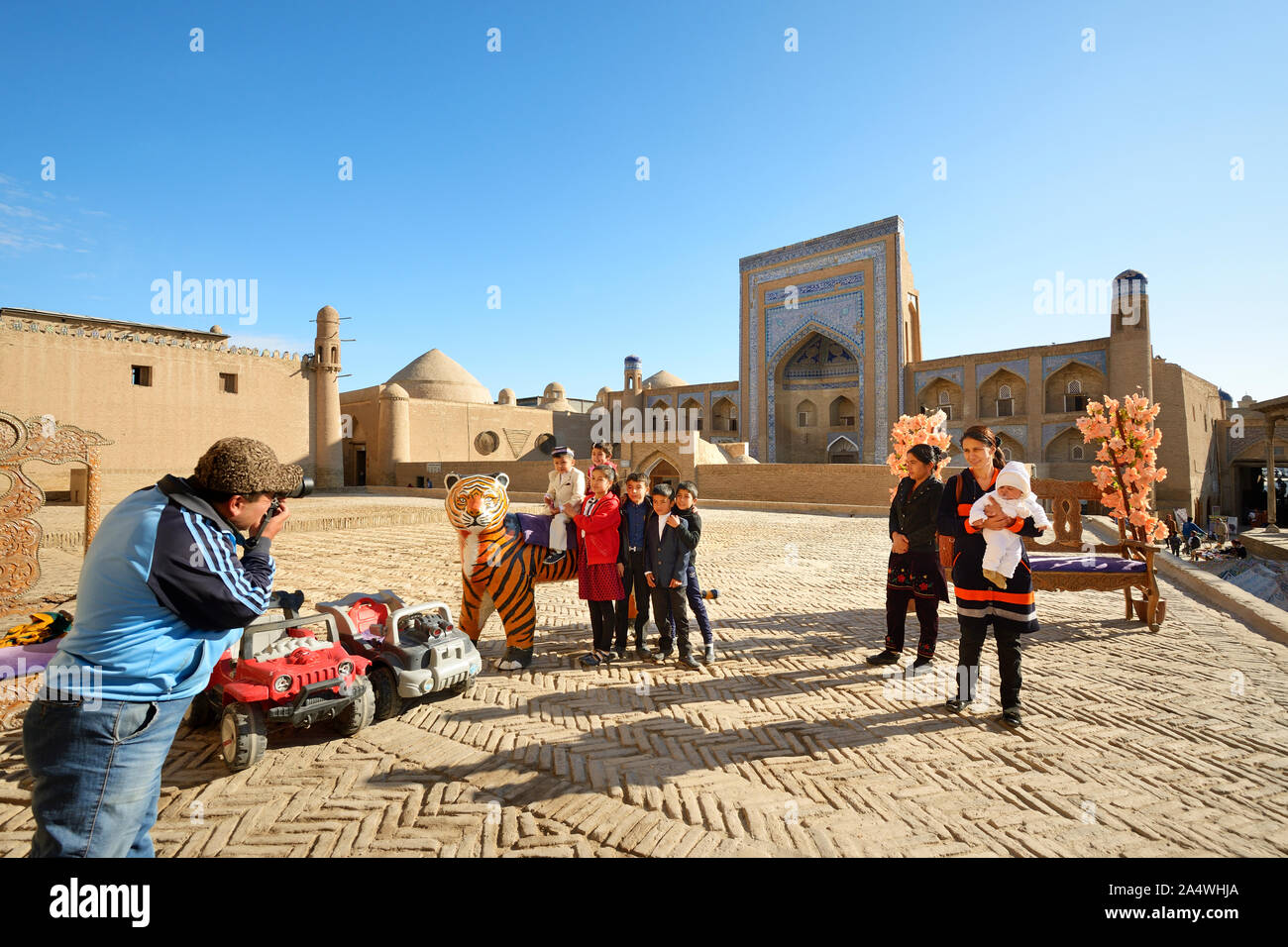 A very popular site to have a family picture taken. Kutlug Murad Inak Madrassah. Khiva, a UNESCO World Heritage Site, Uzbekistan Stock Photo