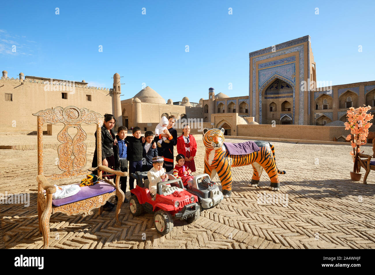 A very popular site to have a family picture taken. Kutlug Murad Inak Madrassah. Khiva, a UNESCO World Heritage Site, Uzbekistan Stock Photo
