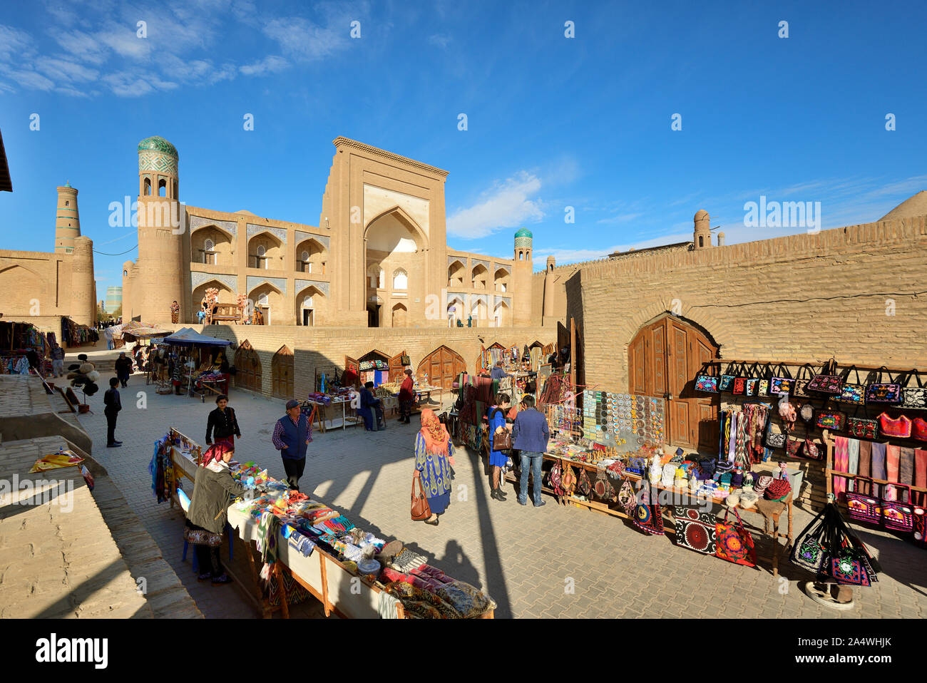 Allakuli Khan Madrassah and the main shopping street. Khiva, a UNESCO World Heritage Site, Uzbekistan Stock Photo