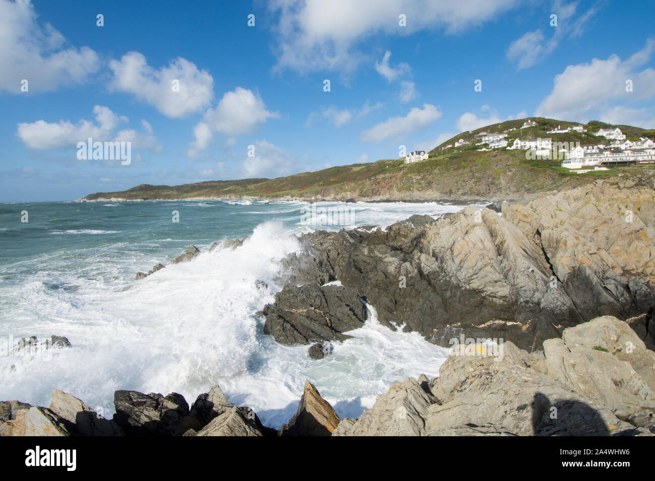 Sea breaking on rocks on foreshore, Woolacombe, view to Morte Point beside Mortehoe, breaking waves Stock Photo