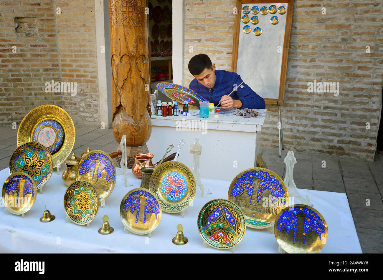 An artist painting plates. Bukhara, a UNESCO World Heritage Site. Uzbekistan Stock Photo