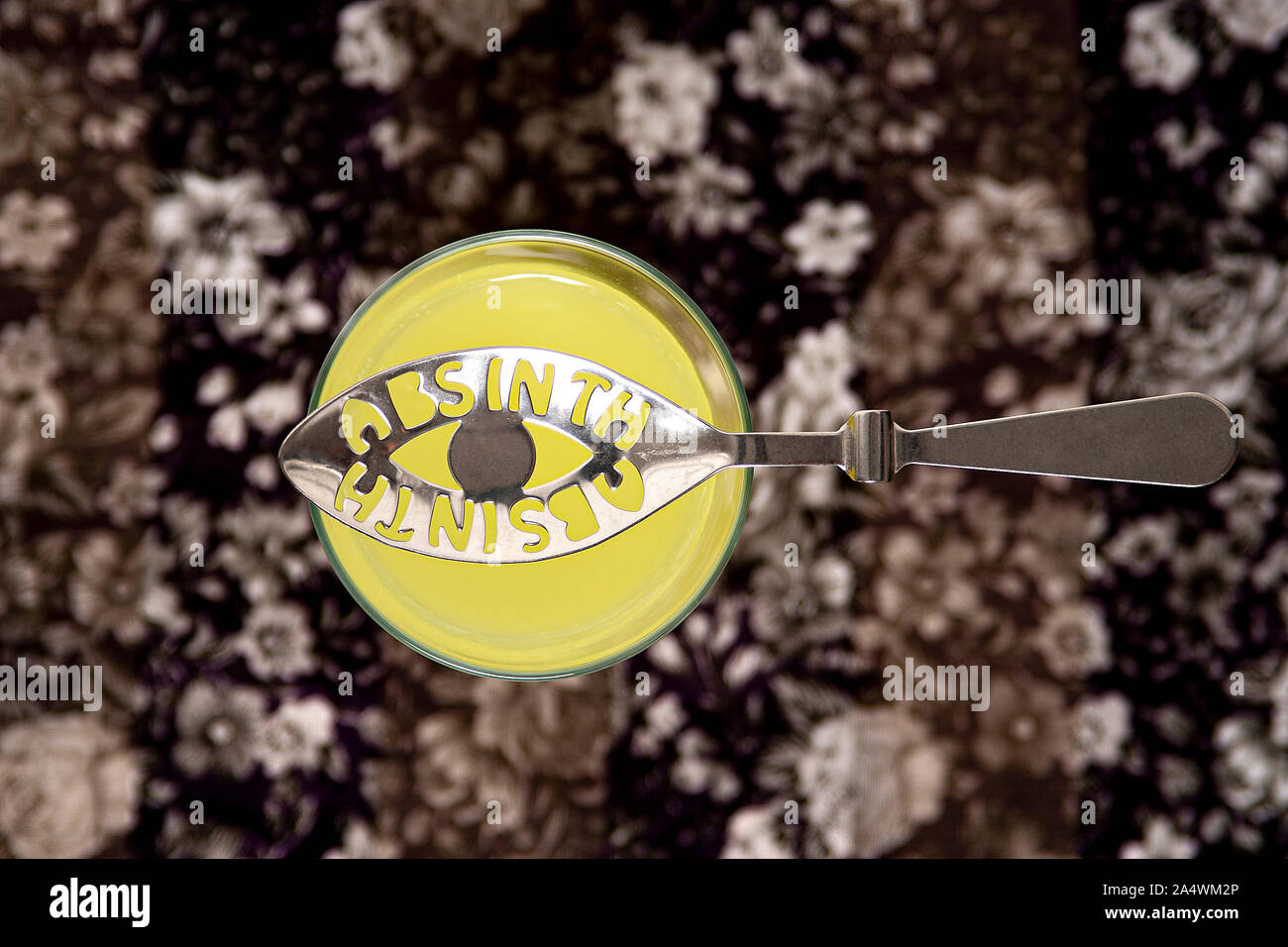 Absinthe spoon on top of glass of absinthe Stock Photo - Alamy