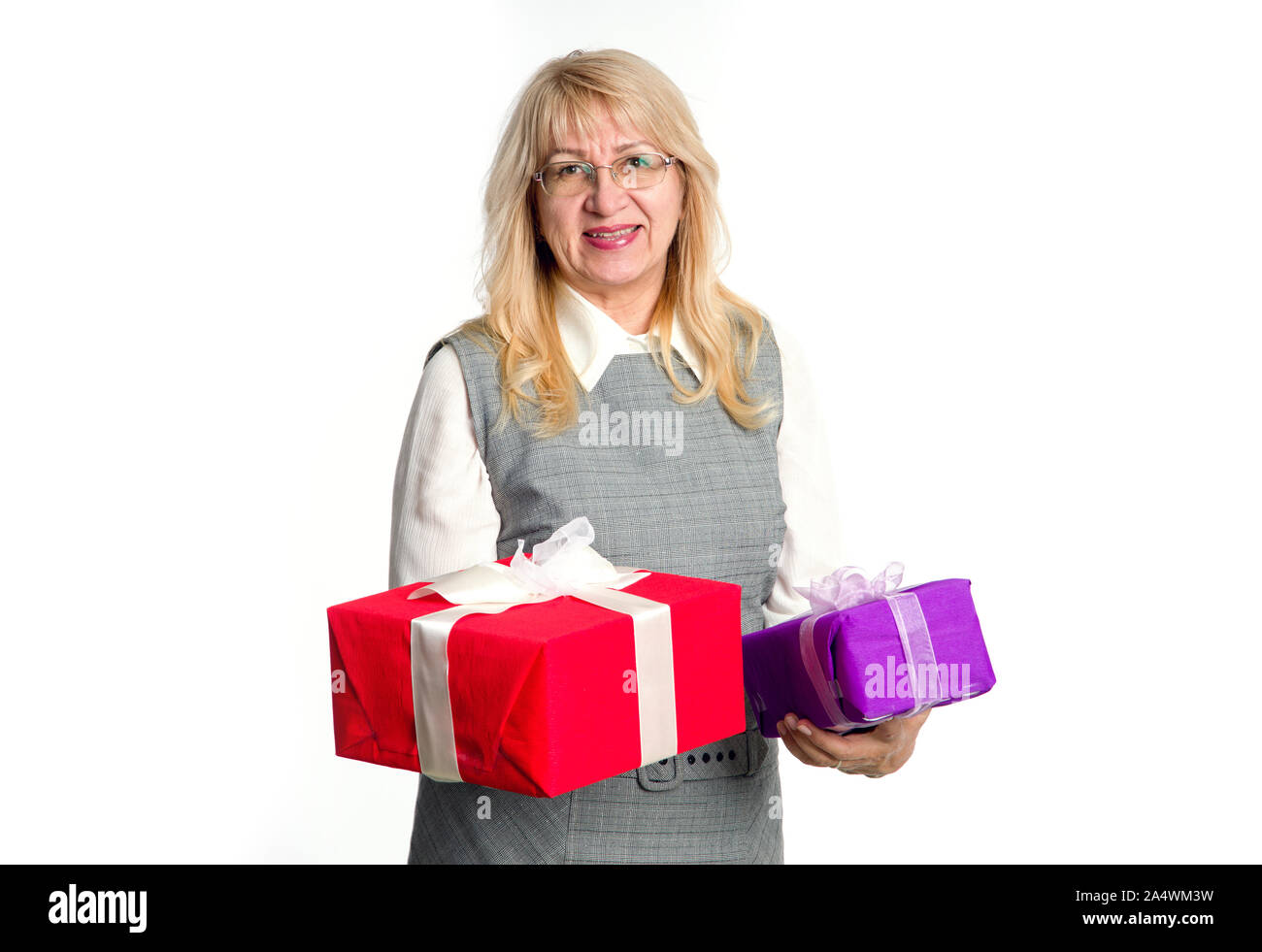 Senior woman with gifts boxes in her hands on a light background. Stock Photo