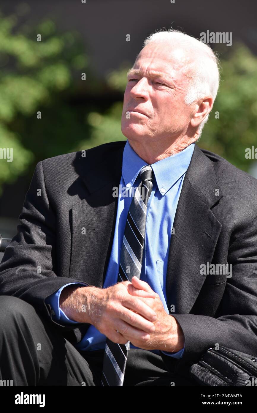 Serious Business Man Wearing Suit And Tie Sitting Stock Photo - Alamy
