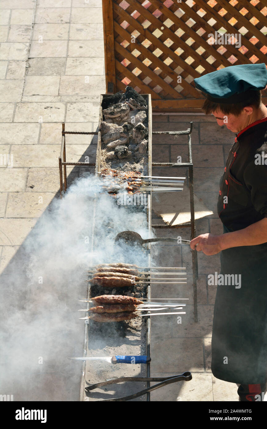 Shashlik, a dish of skewered and grilled lamb meat very tasty and popular in Uzbekistan. Lyabi Hauz, a wonderful and relaxing plaza, the heart of city Stock Photo
