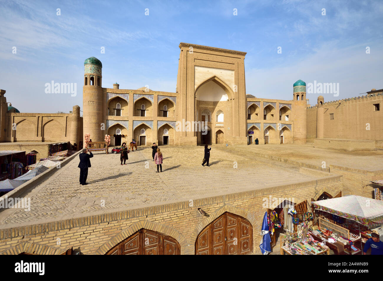 Allakuli Khan Madrassah and the main shopping street. Khiva, a UNESCO World Heritage Site, Uzbekistan Stock Photo