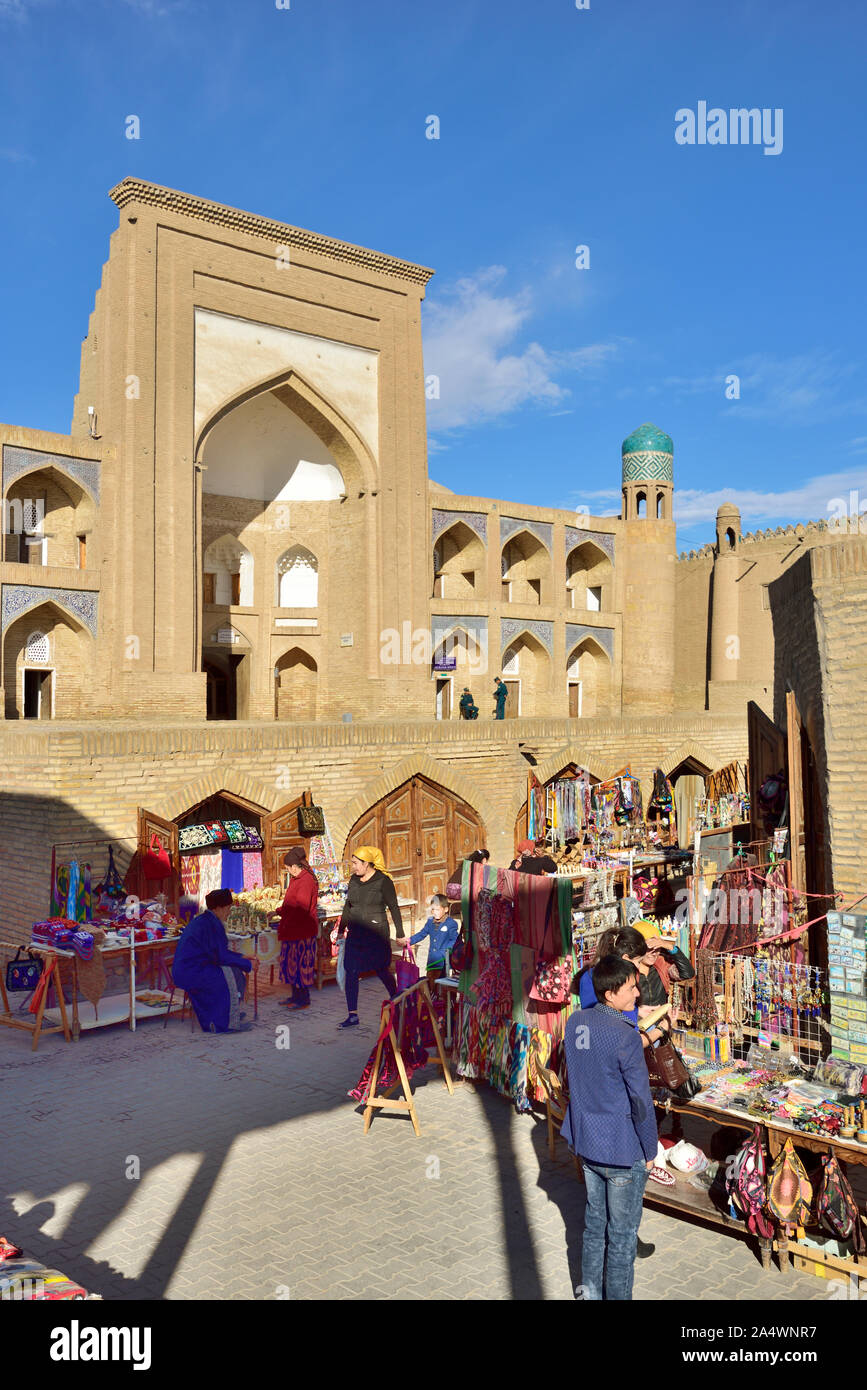 Allakuli Khan Madrassah and the main shopping street. Khiva, a UNESCO World Heritage Site, Uzbekistan Stock Photo