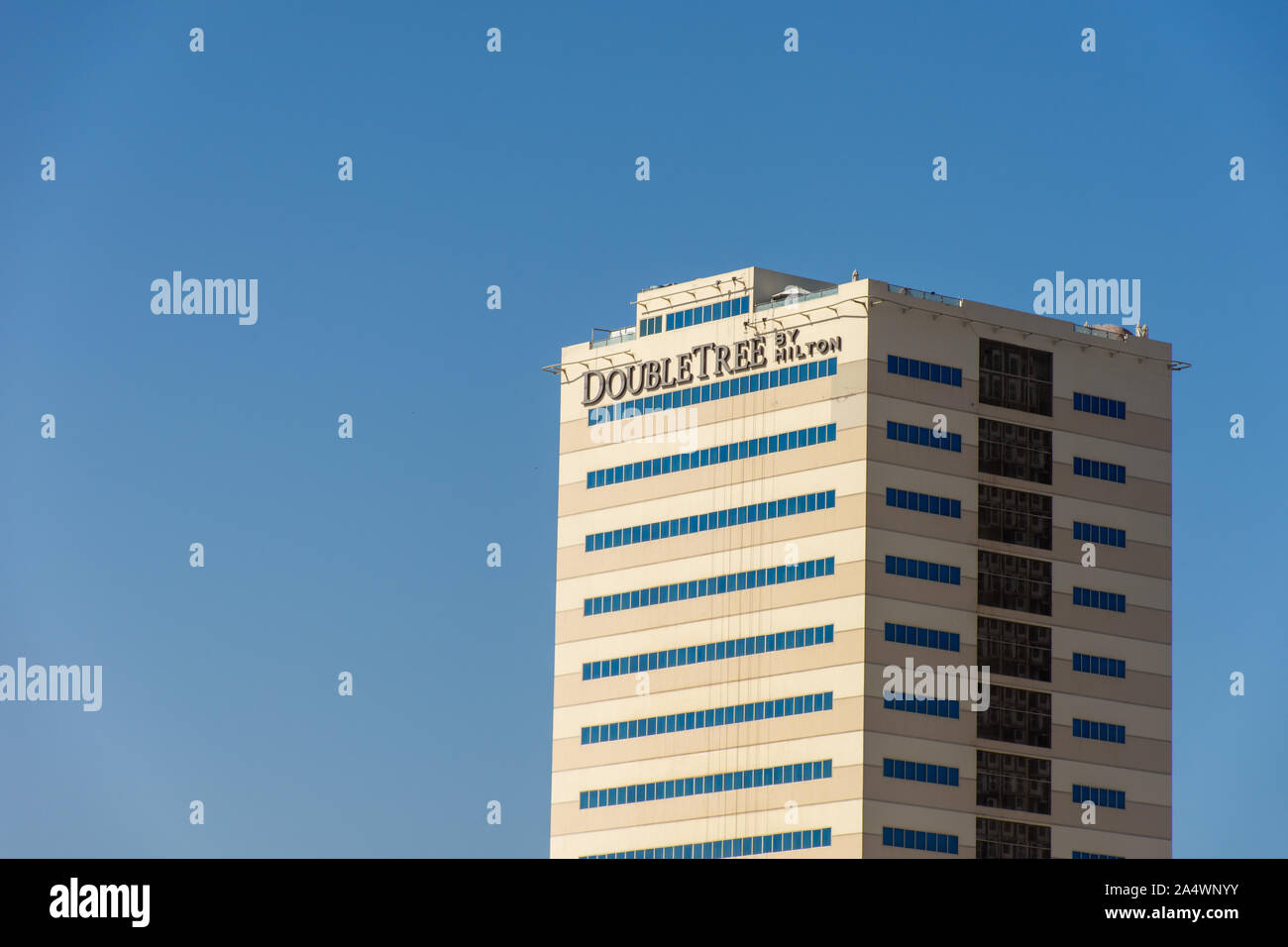 'Ras al Khaimah, Ras al Khaimah/United Arab Emirates - 10/16/2019: 'Hilton Double Tree Hotel building sign against blue sky background ' Stock Photo