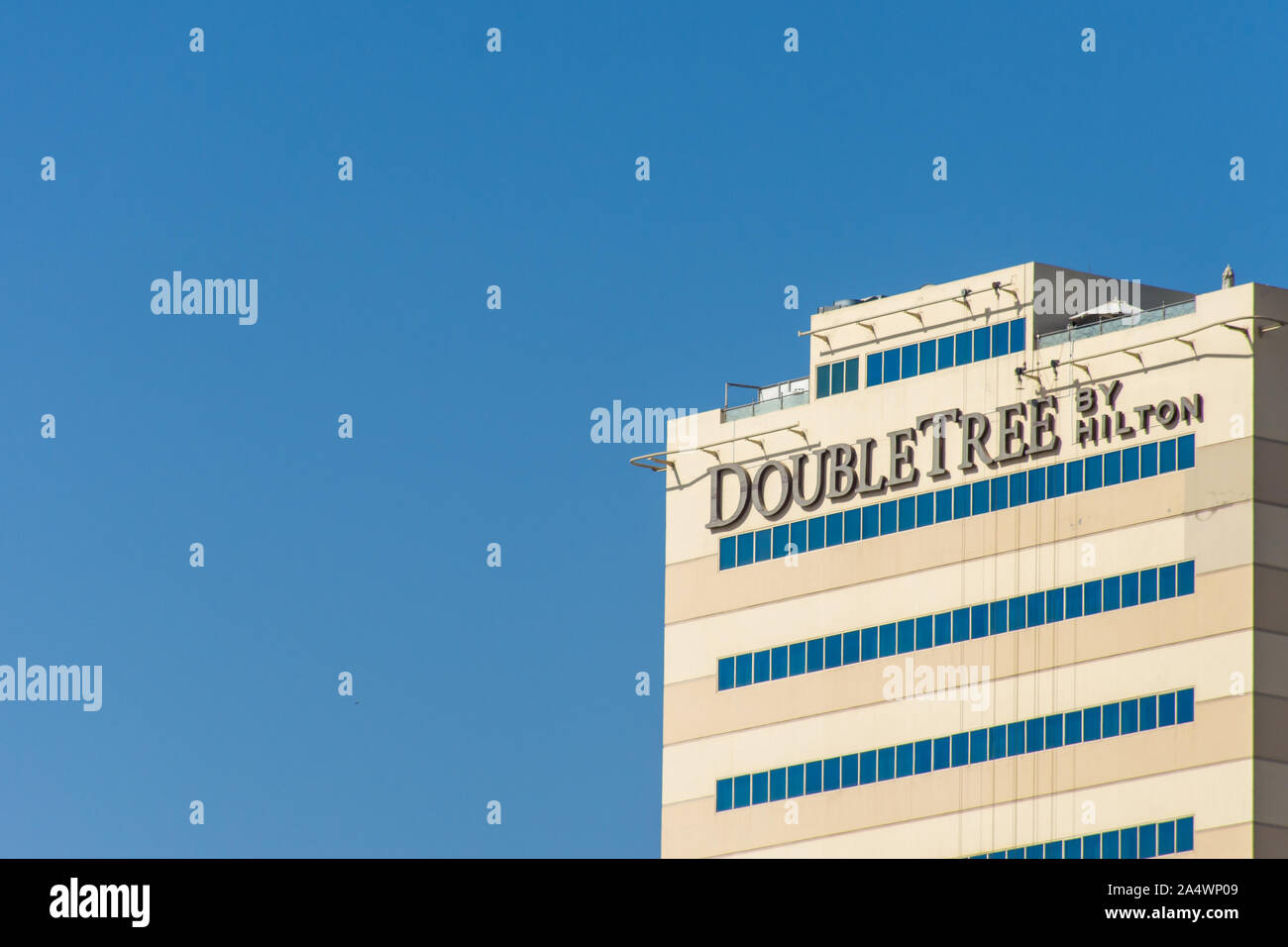 'Ras al Khaimah, Ras al Khaimah/United Arab Emirates - 10/16/2019: 'Hilton Double Tree Hotel building sign against blue sky background ' Stock Photo