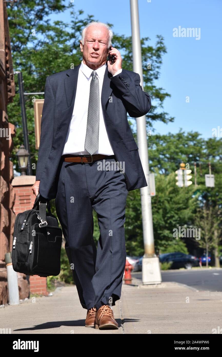 Business Man Using Phone Wearing Suit And Tie Walking Stock Photo - Alamy