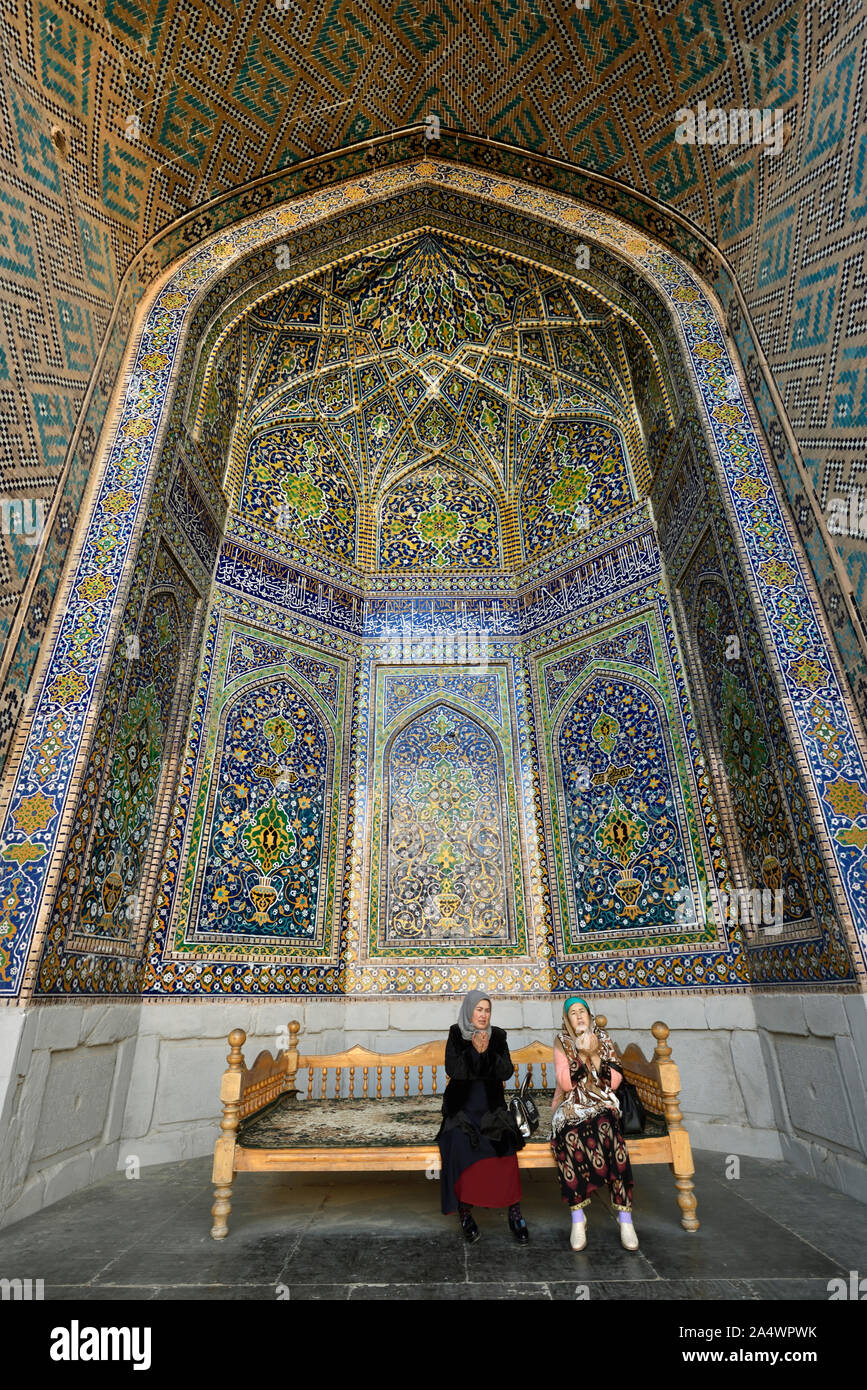 Women praying in Ulugh Beg Madrasah, Registan. A Unesco World Heritage Site, Samarkand. Uzbekistan Stock Photo