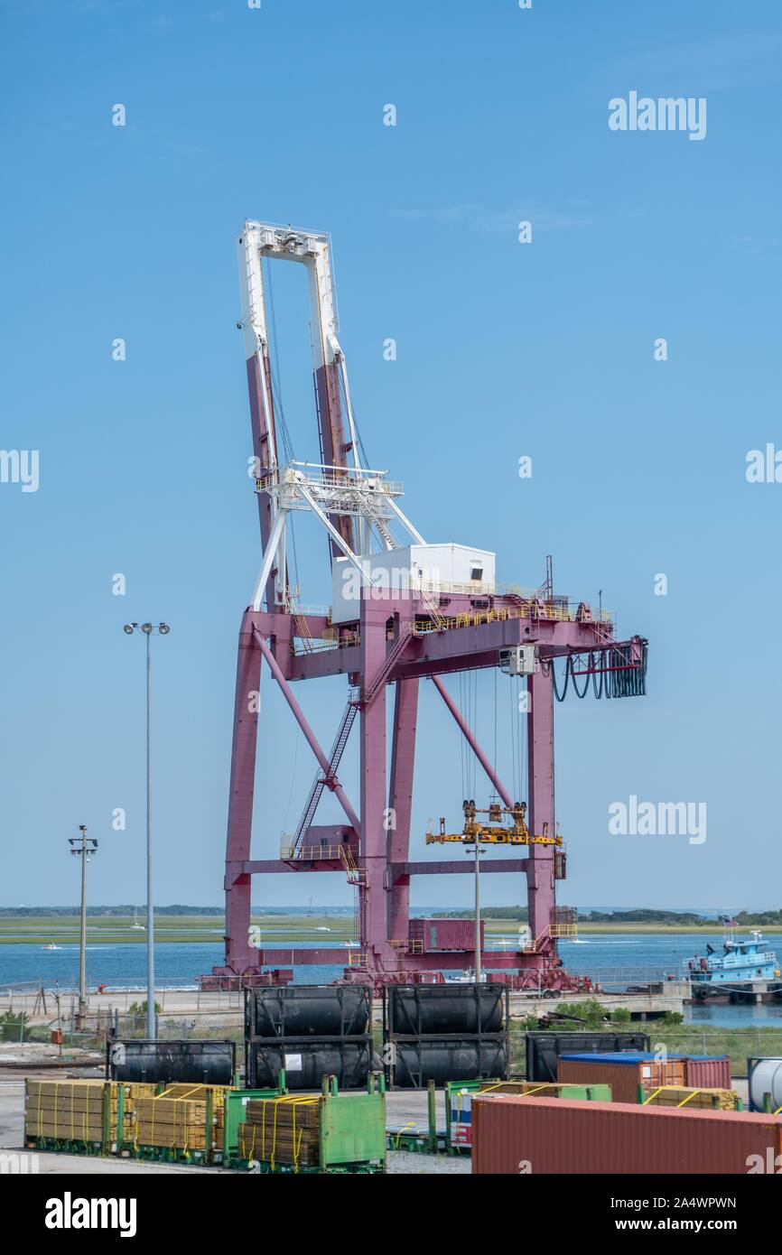 Tall unloading and loading crane for container ships. Stock Photo