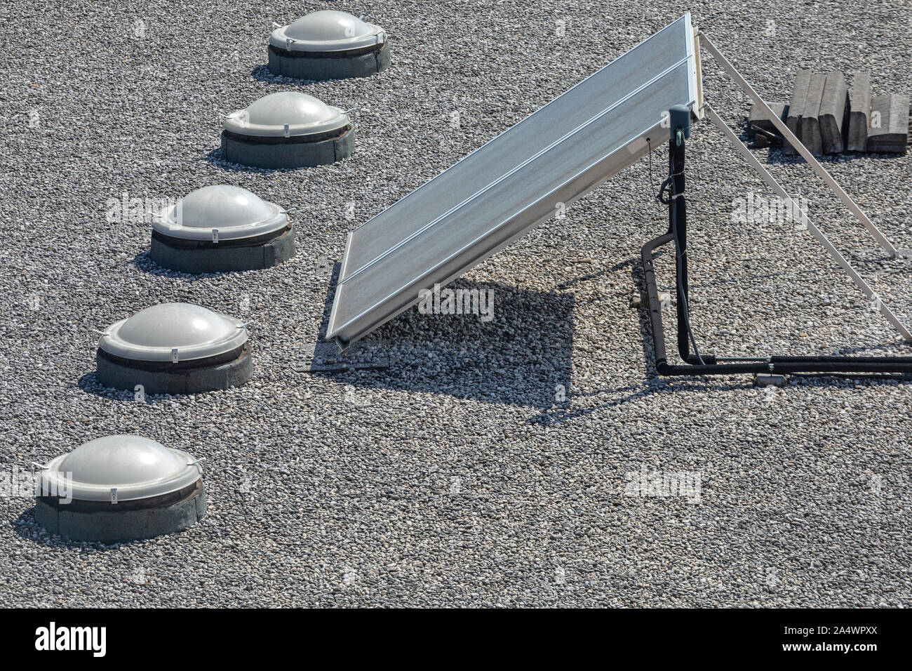 Solar Cells and Skylight Windows at Gravel Flat Roof Stock Photo Alamy