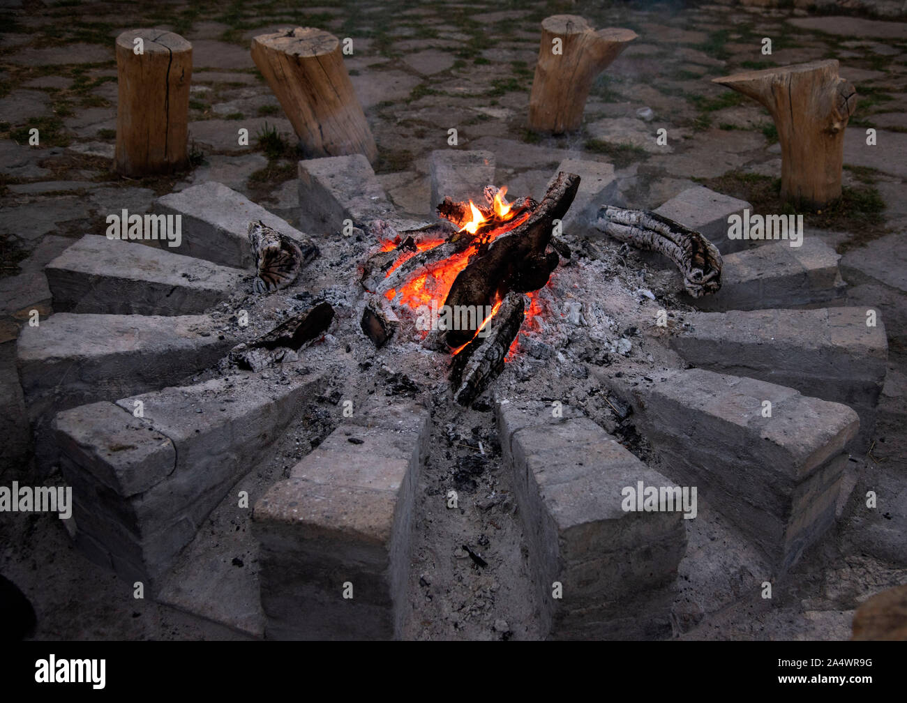Bonfire, burning woodpile and round of stones, campfire or fireplace ...
