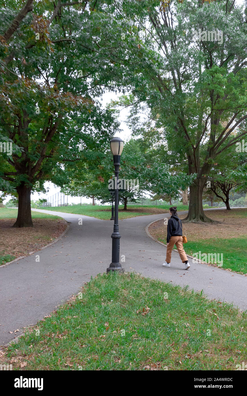 Female at a fork in the road. Stock Photo