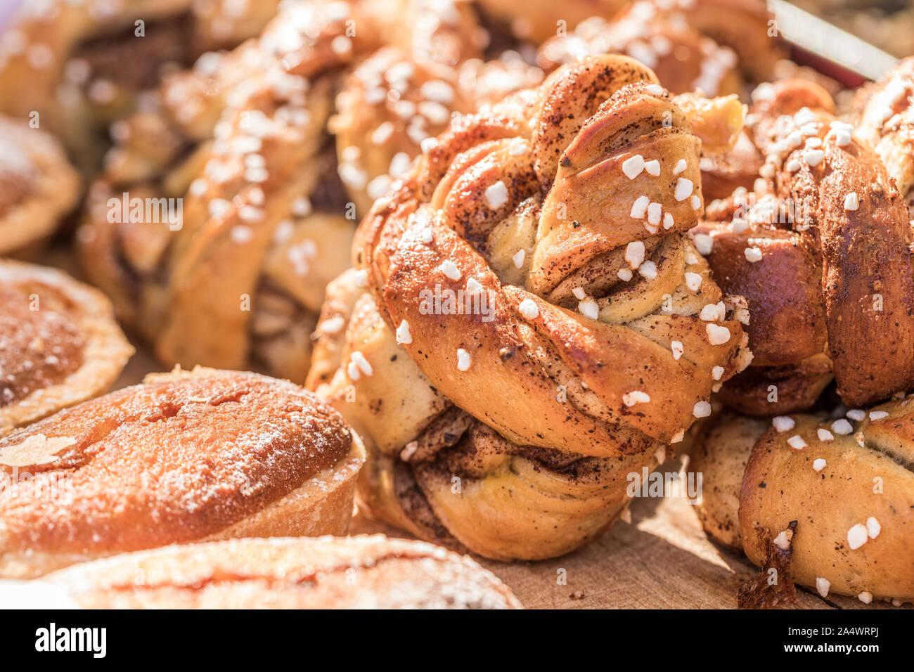 Close up of Swedish twisted cinnamon rolls with nib sugar and cardamom. Stock Photo