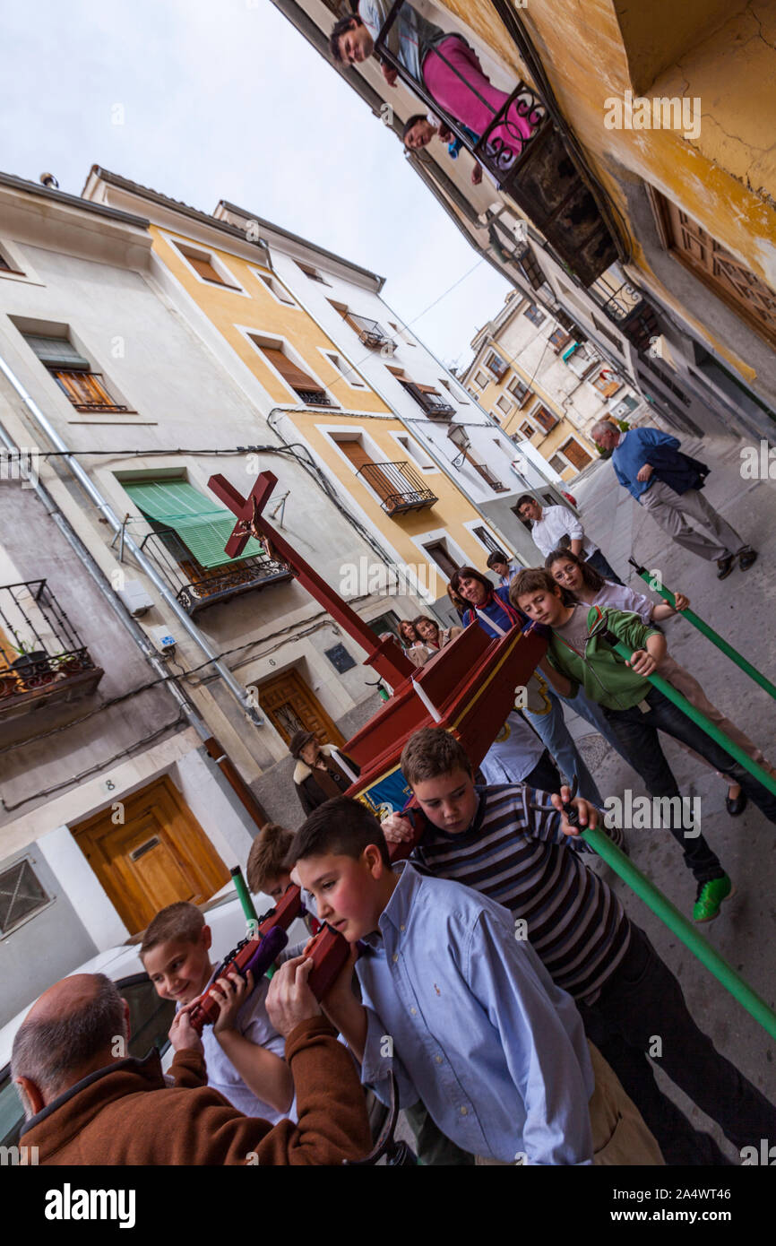 Young boys carrying a paso with a cross practising for the Holy Week procession. in Cuenca, Castille La Mancha, Spain Stock Photo