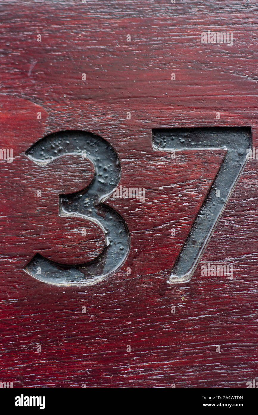 House number 37 engraved in wood Stock Photo