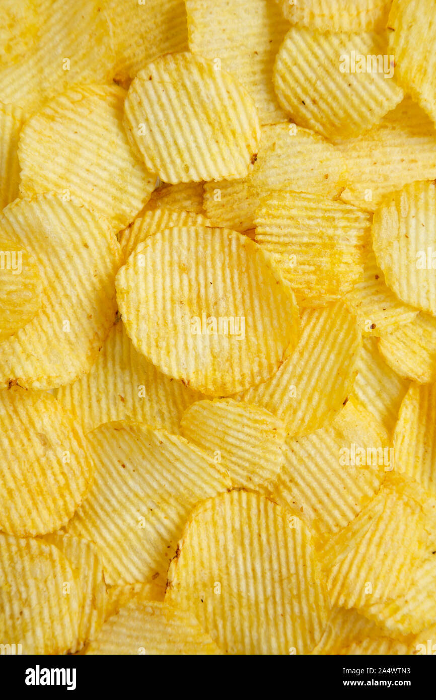 Salted wavy potato chips, top view. Overhead, from above, flat lay.  Close-up Stock Photo - Alamy