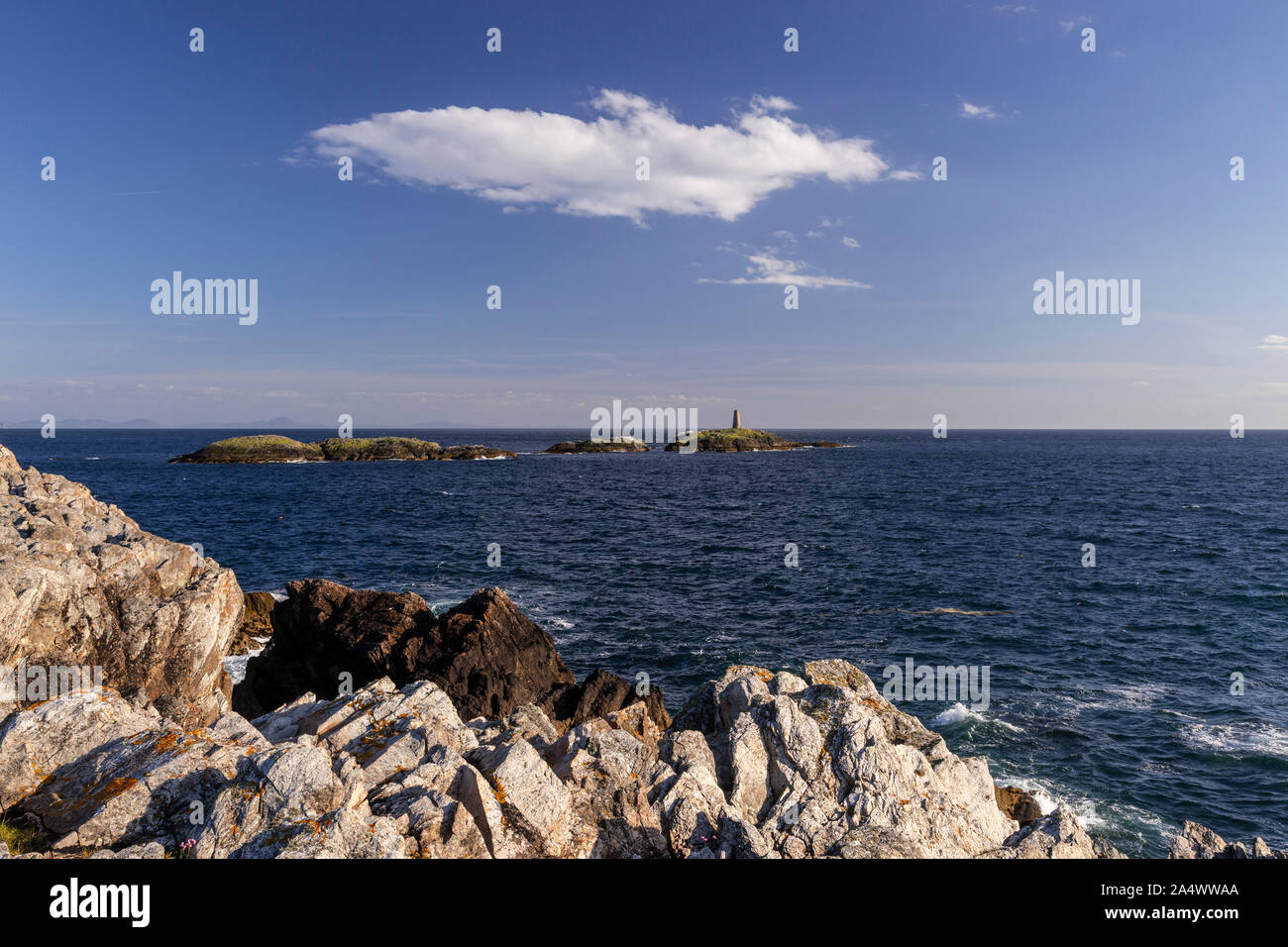 Rocky coastline and island at Rhoscolyn, Anglesey, North Wales on a sunny day Stock Photo