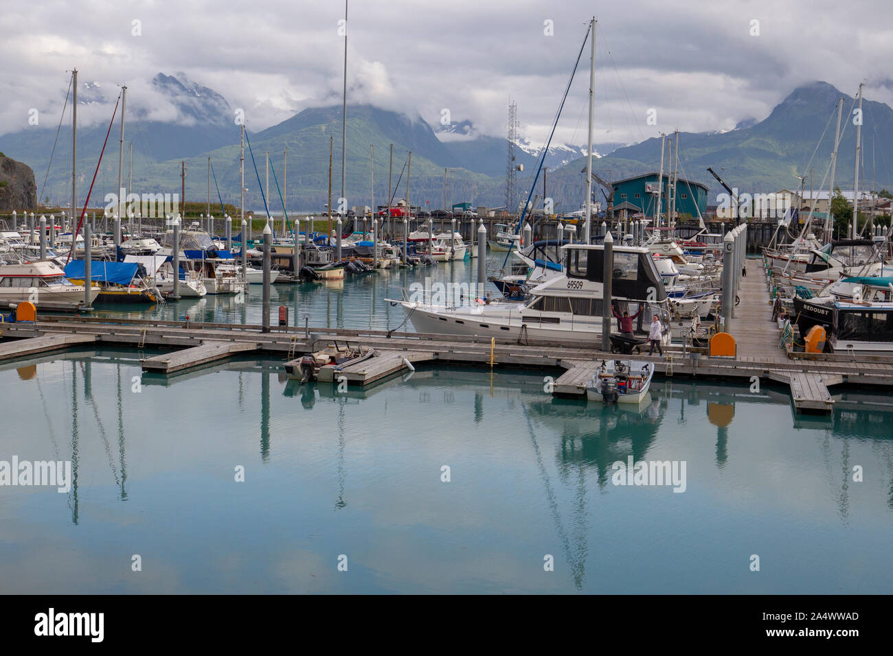 Boats in the harbor at Valdez, Alaska with the Chugach Mountains. Prince William Sound Stock Photo