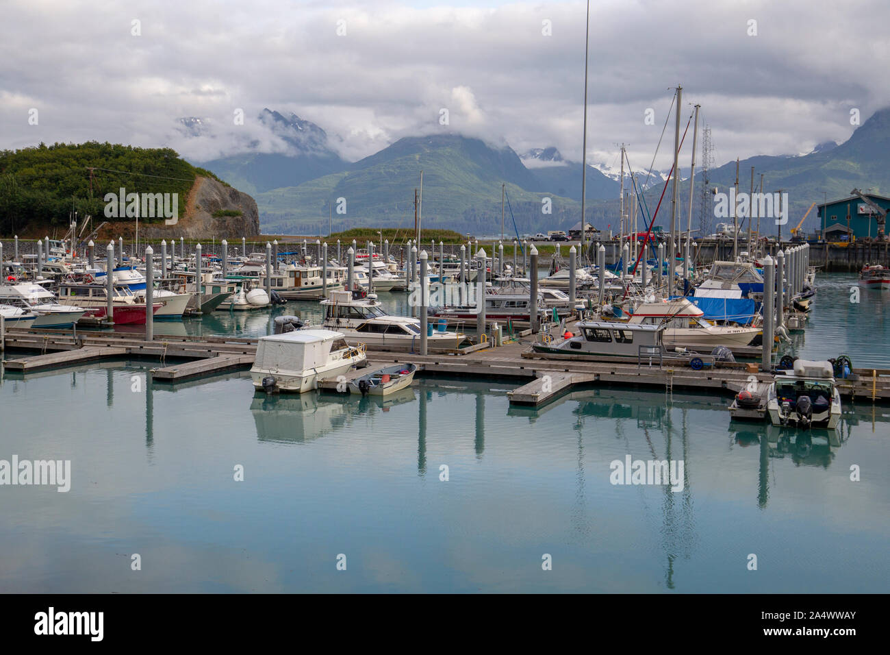 Boats in the harbor at Valdez, Alaska with the Chugach Mountains. Prince William Sound Stock Photo