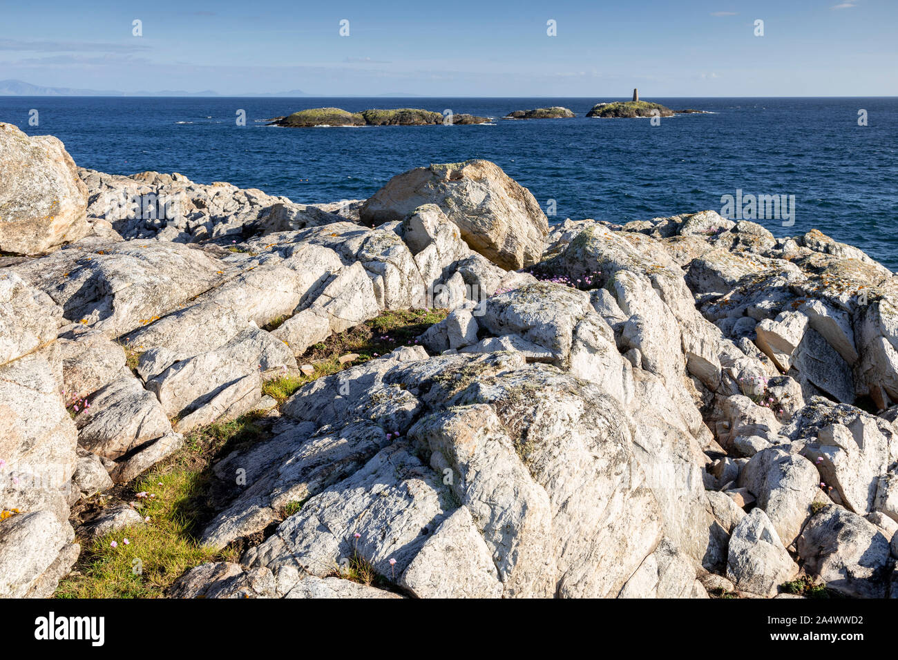 Rocky coastline and island at Rhoscolyn, Anglesey, North Wales on a sunny day Stock Photo