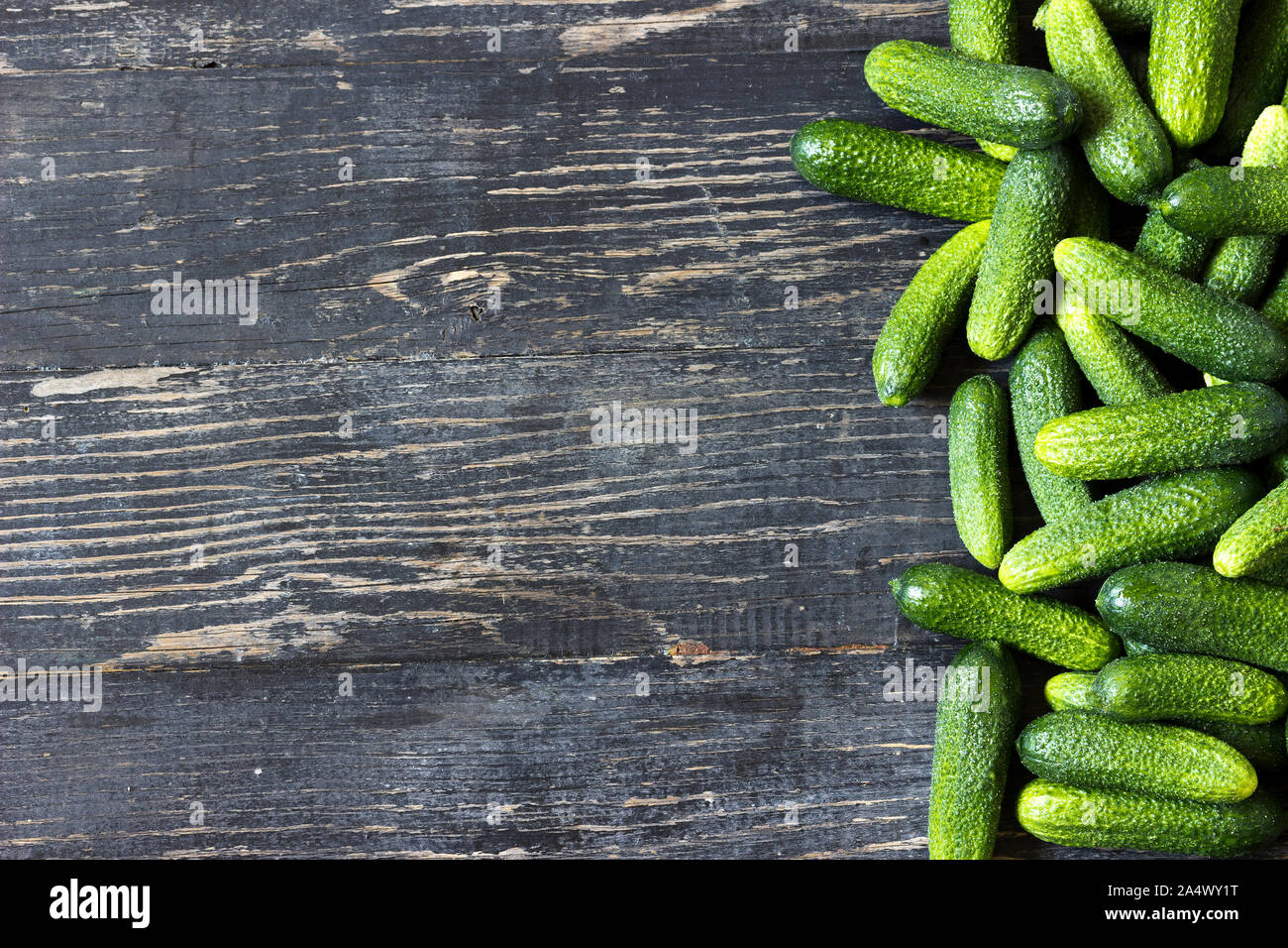 Fresh young green cucumbers on a wooden background Stock Photo