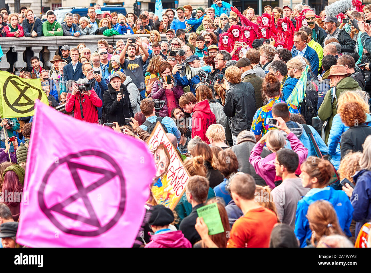 London, U.K. - Oct 16, 2019: Environmental campaigner George Monbiot (centre with megaphone) addresses a crowd of Extinction Rebellion supporters in Trafalgar Square. Stock Photo