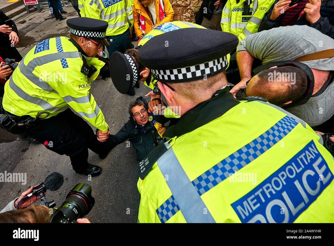 London, U.K. - Oct 16, 2019: Environmental campaigner George Monbiot in the middle of a media and police scrum prior to getting arrested in Trafalgar Square. Stock Photo