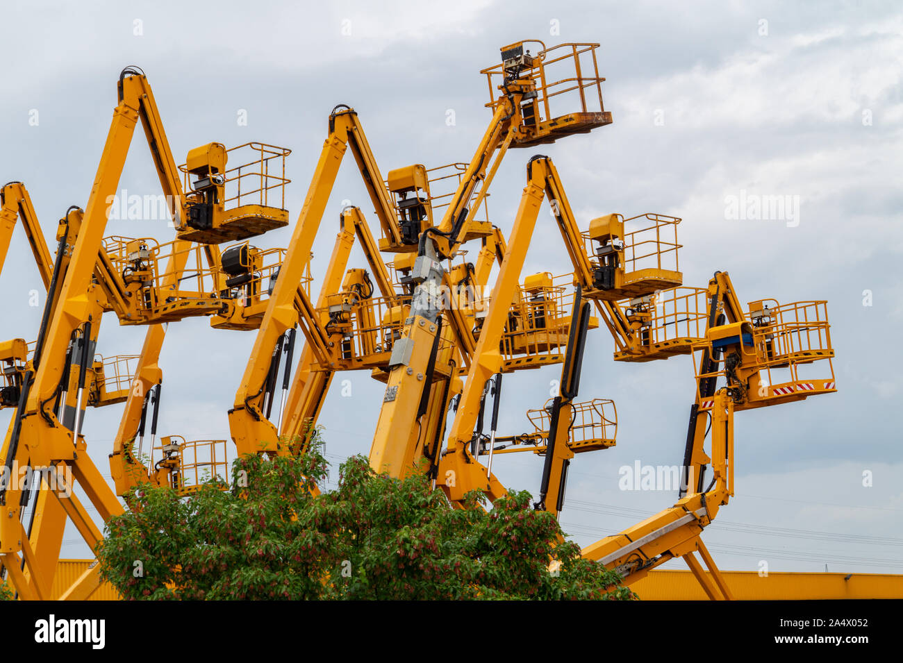 Lot of aerial work platforms. Articulating boom lifts. Construction equipment Stock Photo Alamy