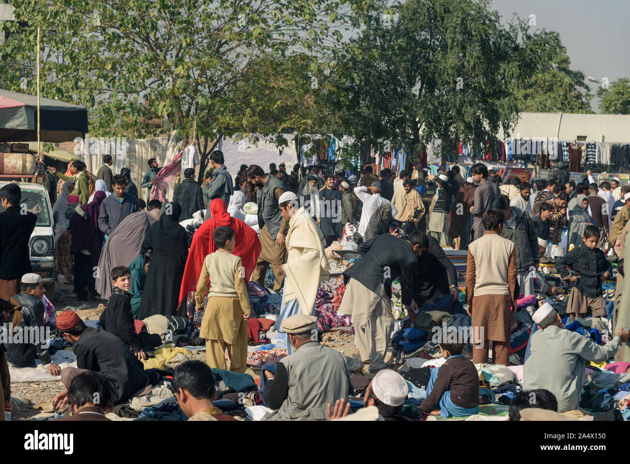 PESHAWAR, PAKISTAN - DECEMBER 13, 2015:  Shoppers and vendor in the crowded sunday  bazaar of Hayatabad town in Peshawar city Pakistan. Stock Photo