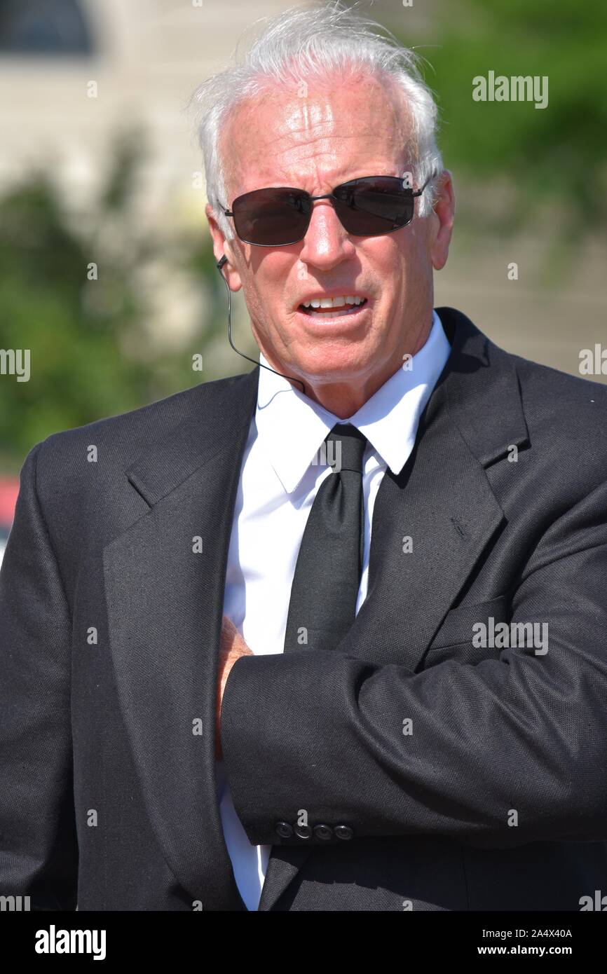 Handsome Senior Security Guard Smiling Wearing Sunglasses Stock Photo