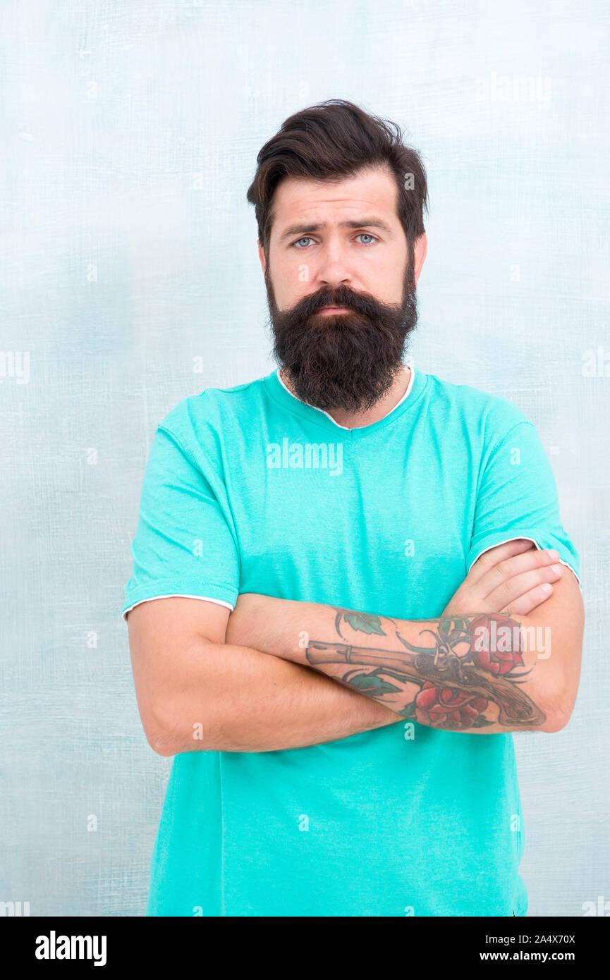 Bearded hipster brutal guy. Products is essential for maintaining men beard care. Grow long beard. Challenges like dryness ingrown hairs and irritation. Find best beard design shape for facial hair. Stock Photo