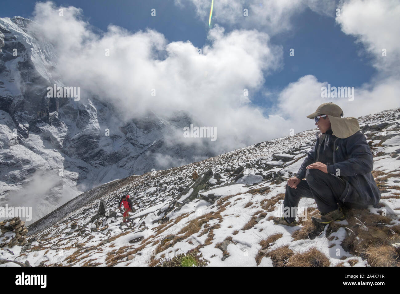 A young sherpa guide contemplates the view from his mountain office Stock Photo
