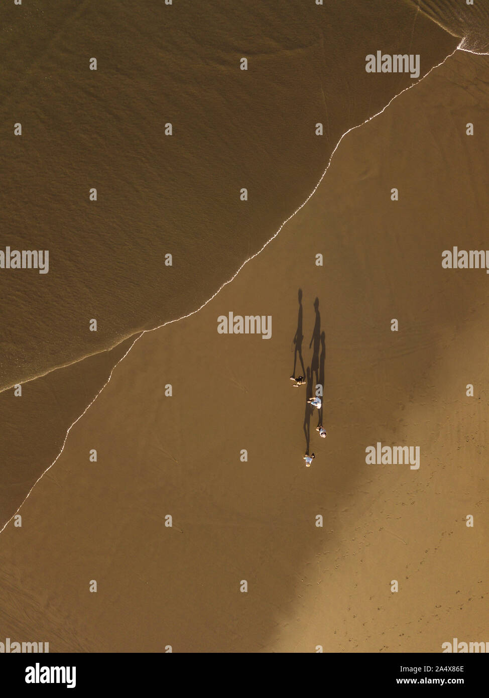 Aerial view of people walking at the beach Stock Photo - Alamy