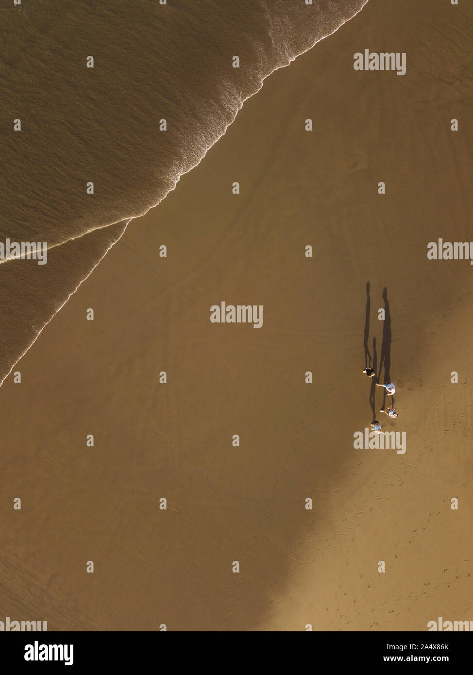 Aerial view of people walking at the beach Stock Photo - Alamy