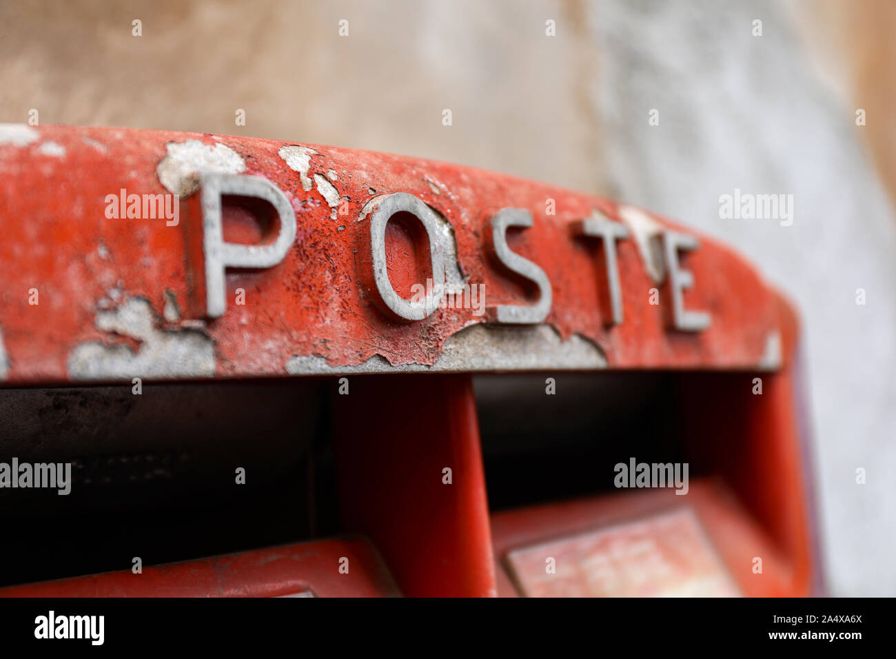 Weathered Poste Italiane mail box with flaking paint in Rome, Italy. Close-up with selective focus. Stock Photo