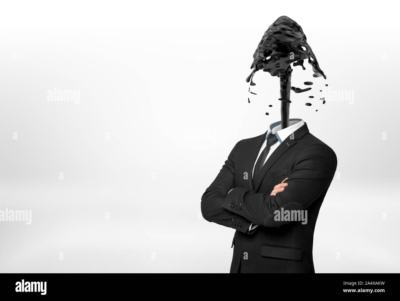 A businessman with crossed hands on white background has his head replaces with a fountain of black oil. Stock Photo