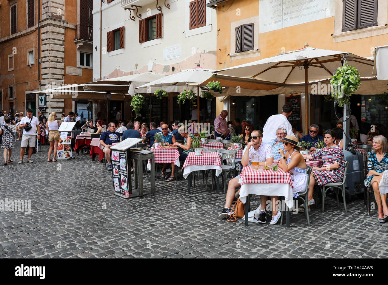 Tourists having a drink at outdoor cafe bar restaurant in the Piazza della Rotonda in Rome, Italy Stock Photo