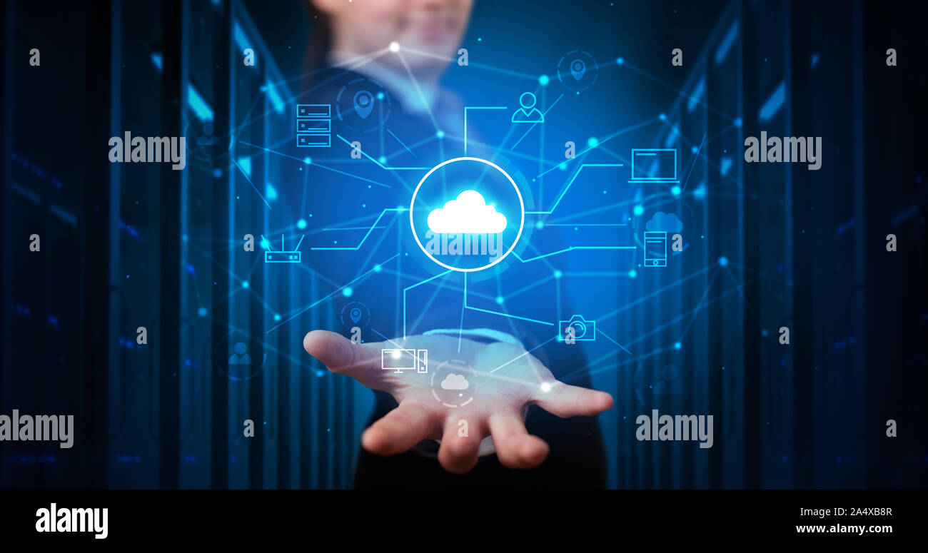 Man holding hologram projection displaying cloud technology symbols Stock Photo