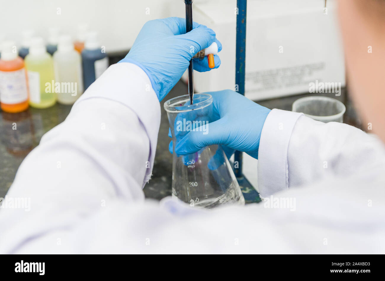 Woman hands performing titration test on chemical quality control Stock Photo Alamy