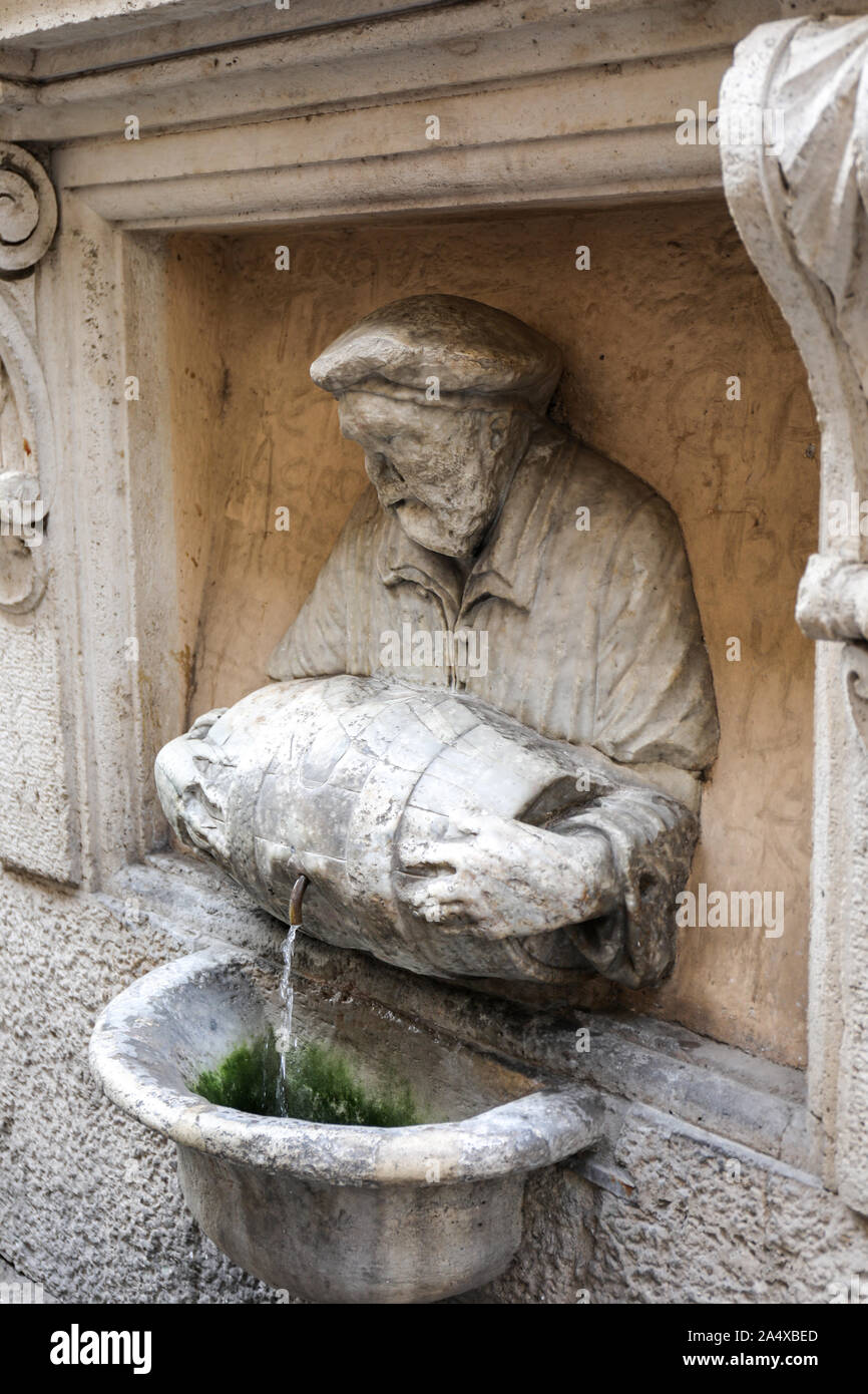 Fontana del Facchino - Fountain of the Laborer - by Jacopo Del dating back to 1580. The face of the statue is almost worn out. Via Lata, Rome, Italy. Stock Photo