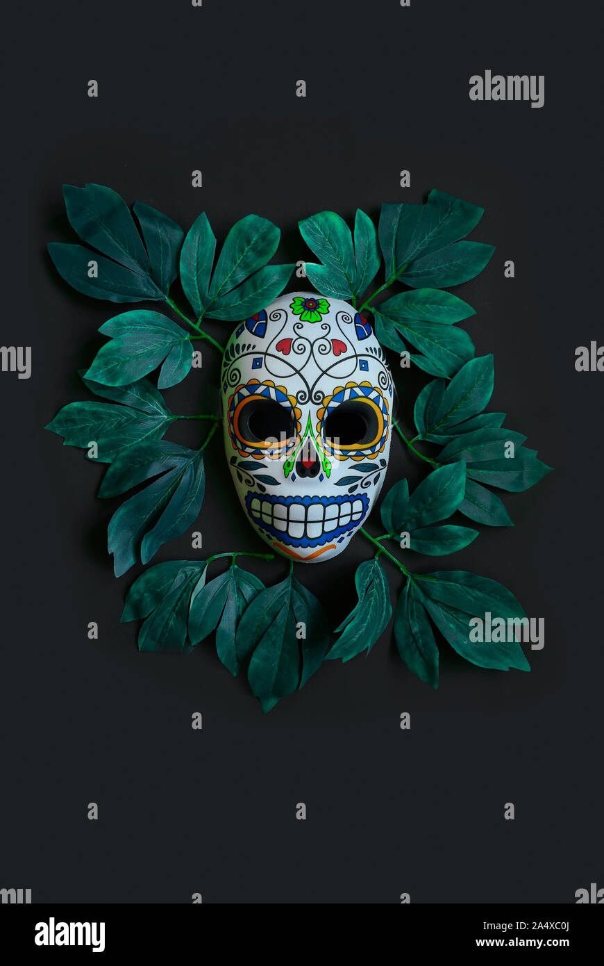 Sugar skull mask with flowers used for celebrating Day of the Dead in