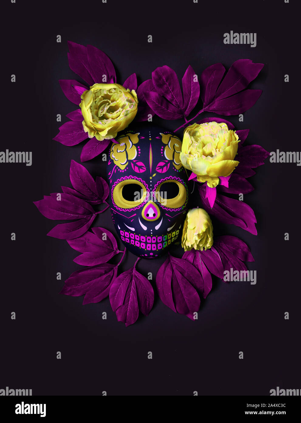 Sugar skull mask with flowers used for celebrating Day of the Dead in hispanic culture. Mexican symbol of the traditional Dia de los Muertos. Hallowee Stock Photo