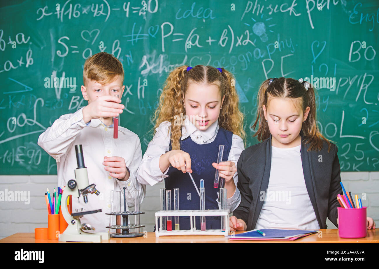 Lab microscope. students doing biology experiments with microscope. Little kids learning chemistry in school lab. Chemistry microscope. Little children at laboratory. Using modern technologies. Stock Photo