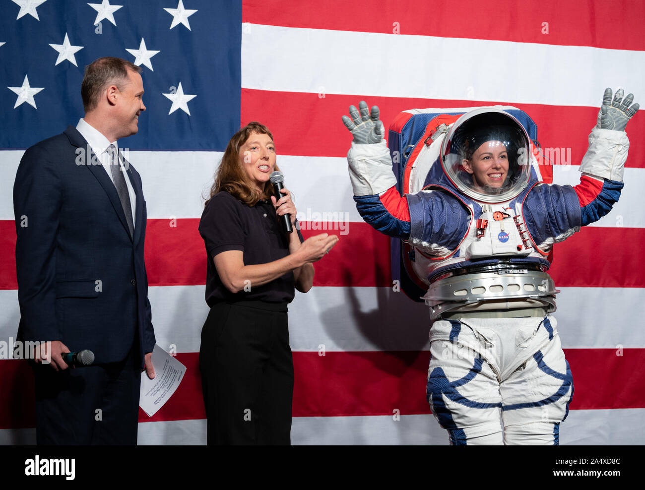NASA Administrator Jim Bridenstine, left, and Amy Ross, a spacesuit engineer at NASA's Johnson Space Center, left, are seen with Kristine Davis, a spacesuit engineer at NASA's Johnson Space Center, wearing a ground prototype of NASA's new Exploration Extravehicular Mobility Unit (xEMU), during a demonstration of the suit, on October 15, 2019, at NASA Headquarters in Washington. The xEMU suit improves on the suits previous worn on the Moon during the Apollo era and those currently in use for spacewalks outside the International Space Station and will be worn by first woman and next man as they Stock Photo