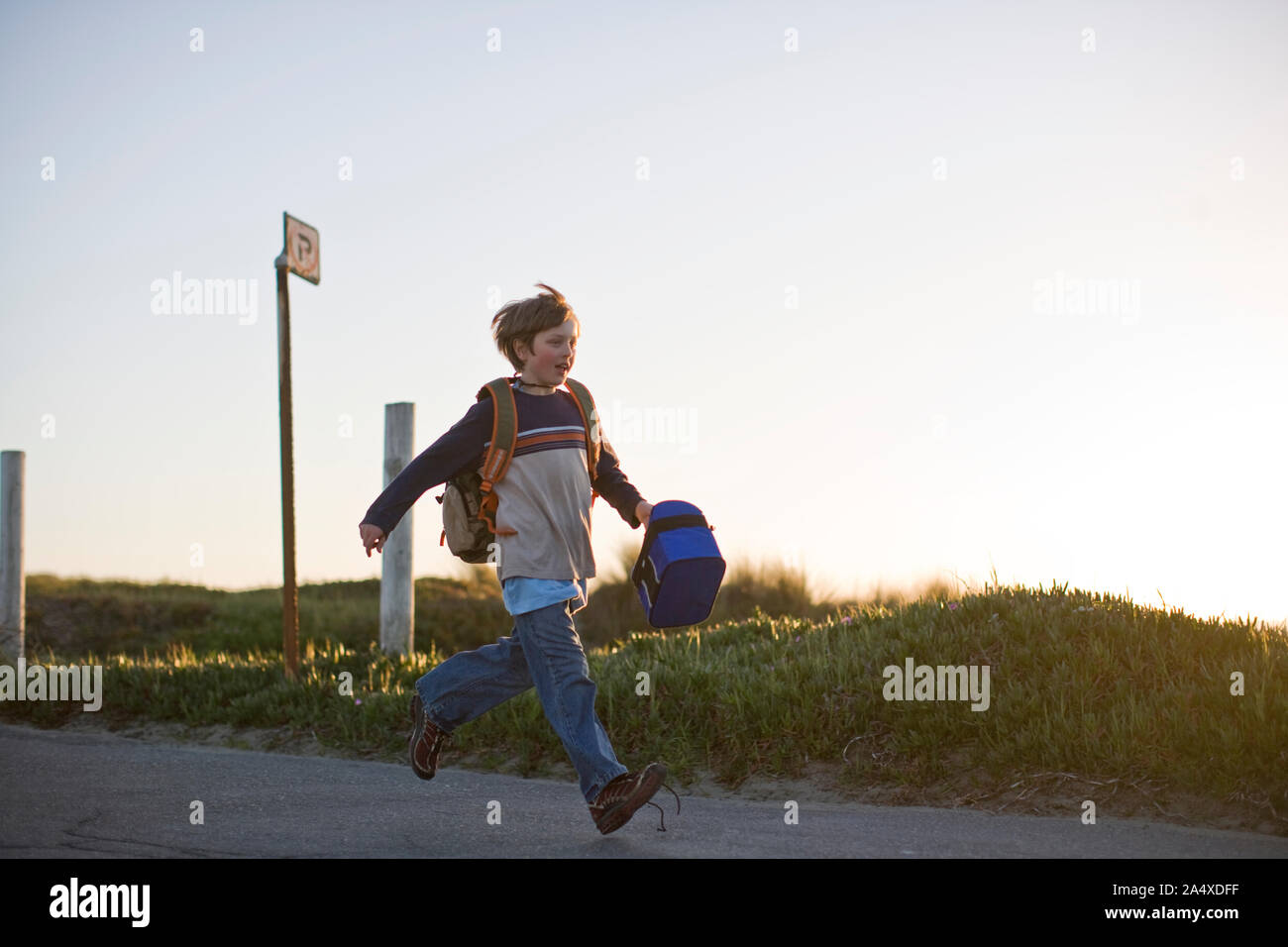 Young boy walking home from school Stock Photo Alamy