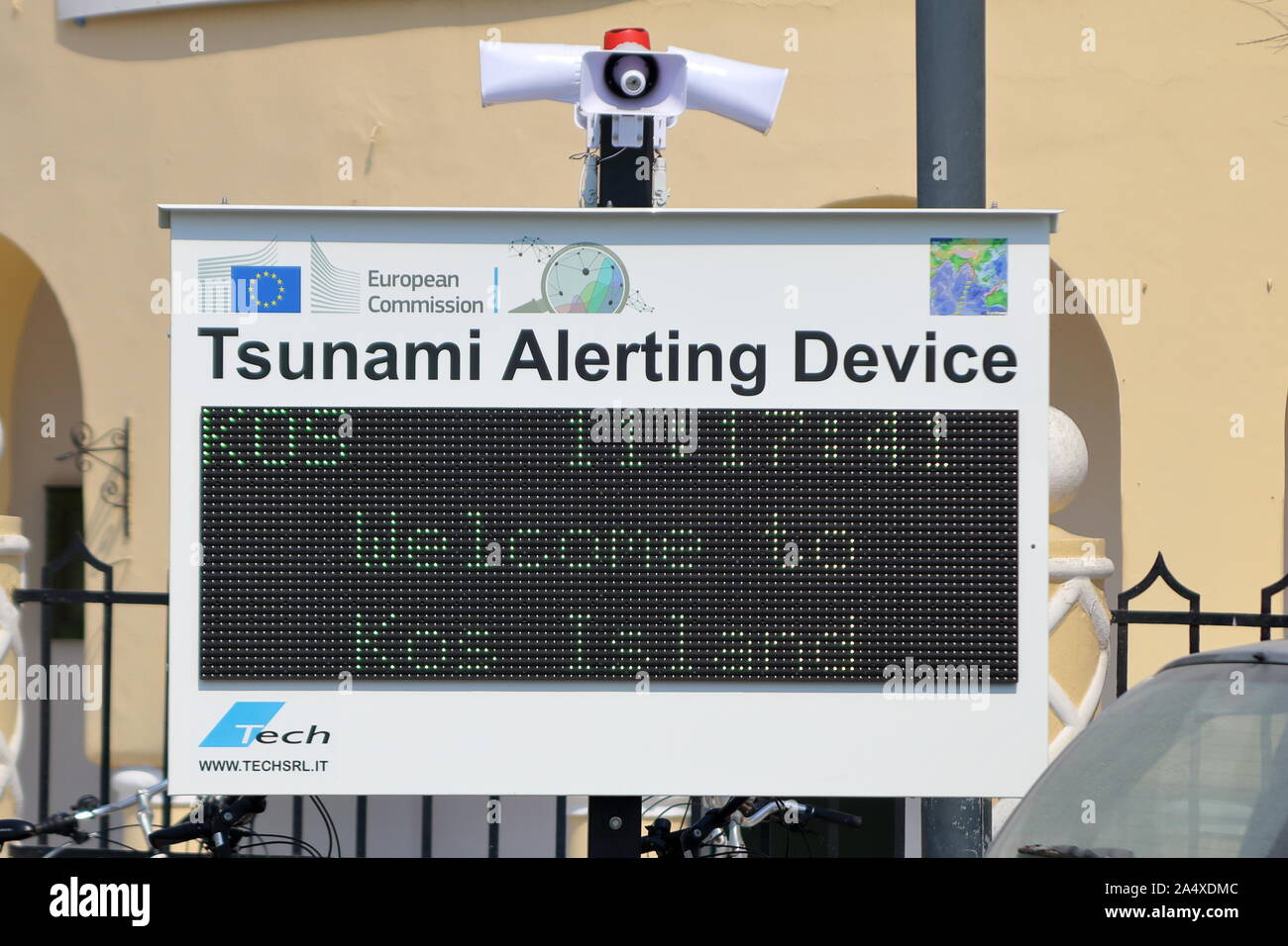 tsunami early alerting device in Kos harbour currently displaying the time and a welcome. Stock Photo