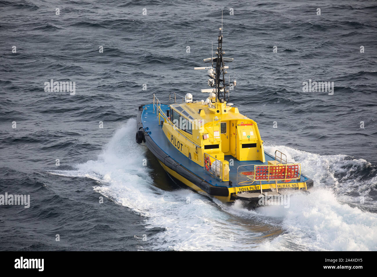 Blue and yellow coloured Pilot Boat on the Atlantic Ocean near Halifax ...